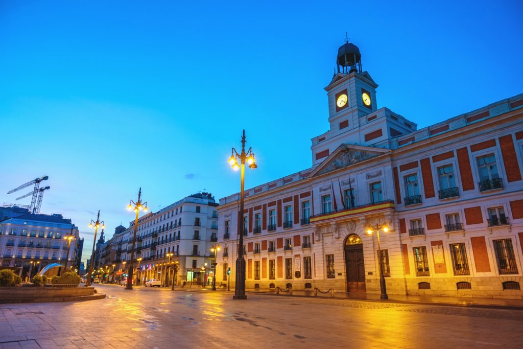 Madrid Spain, night city skyline at Puerta del Sol and Clock Tower of Sun Gate
